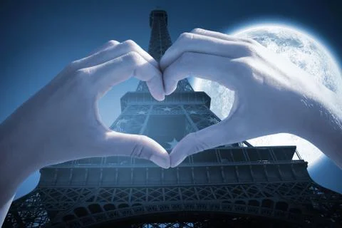 Composite image of hands making heart shape on the beach Stock Photos