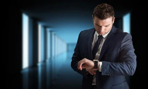 Composite image of handsome businessman checking the time Stock Photos