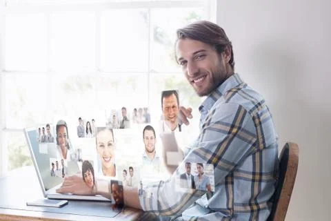 Composite image of handsome man sitting at table using laptop Stock Illustration