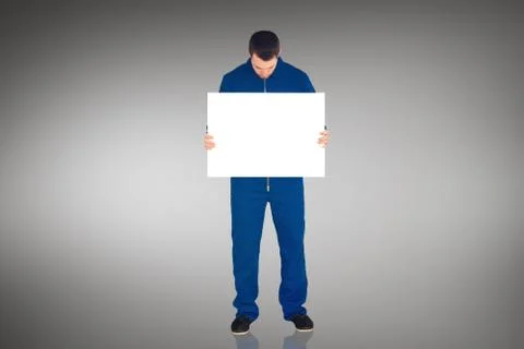 Composite image of handsome mechanic showing card Stock Illustration