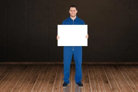 Composite image of handsome mechanic showing card Stock Illustration