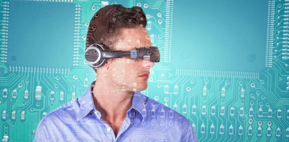Composite image of handsome young man with virtual reality simulator Foto stock