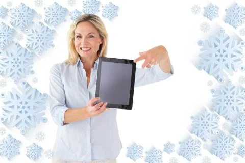 Composite image of happy blonde pointing to her tablet pc screen Illustrazione stock
