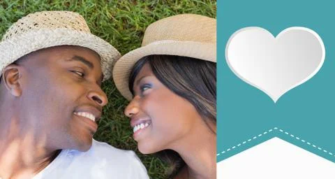Composite image of happy couple lying in garden together Ilustração Stock