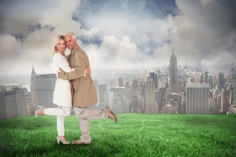 Composite image of happy couple posing in trench coats Ilustración de archivo