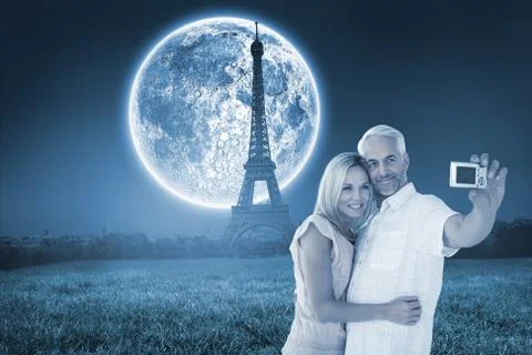 Composite image of happy couple posing for a selfie Ilustración de archivo