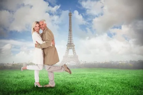 Composite image of happy couple posing in trench coats Ilustração Stock