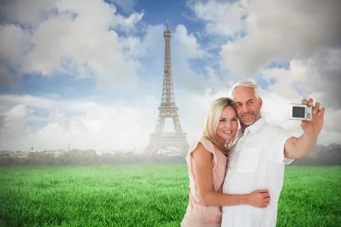 Composite image of happy couple posing for a selfie Stock Photos