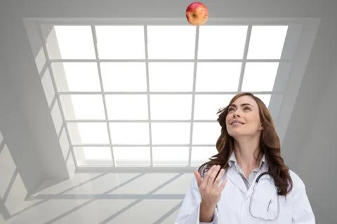 Composite image of happy doctor throwing apple Stock-Illustration