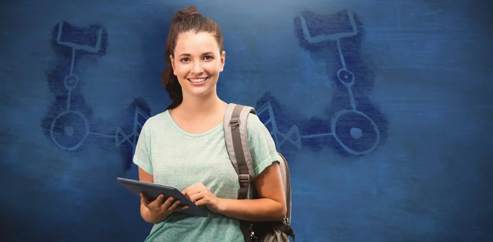 Composite image of happy student using tablet Fotos Stock