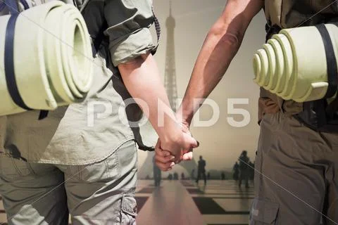 Composite image of hitch hiking couple standing holding hands on the road Stock Photos