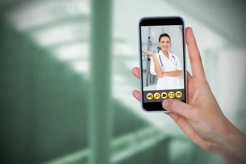 Composite image of human hand holding mobile phone against white background Stock Photos