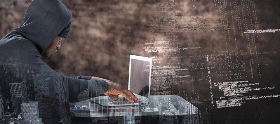 Composite image of male hacker using laptop on table 스톡 사진