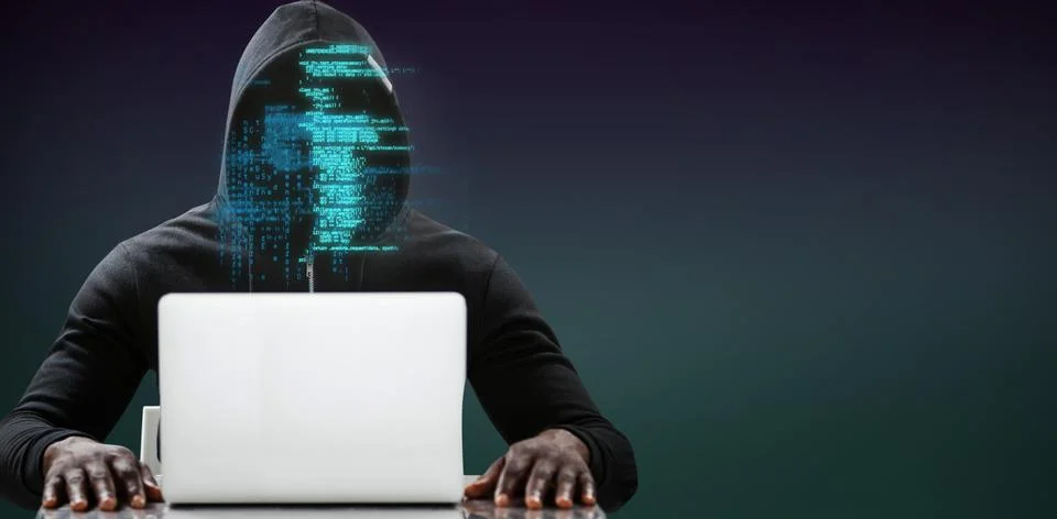 Composite image of male hacker using laptop on table 库存照片