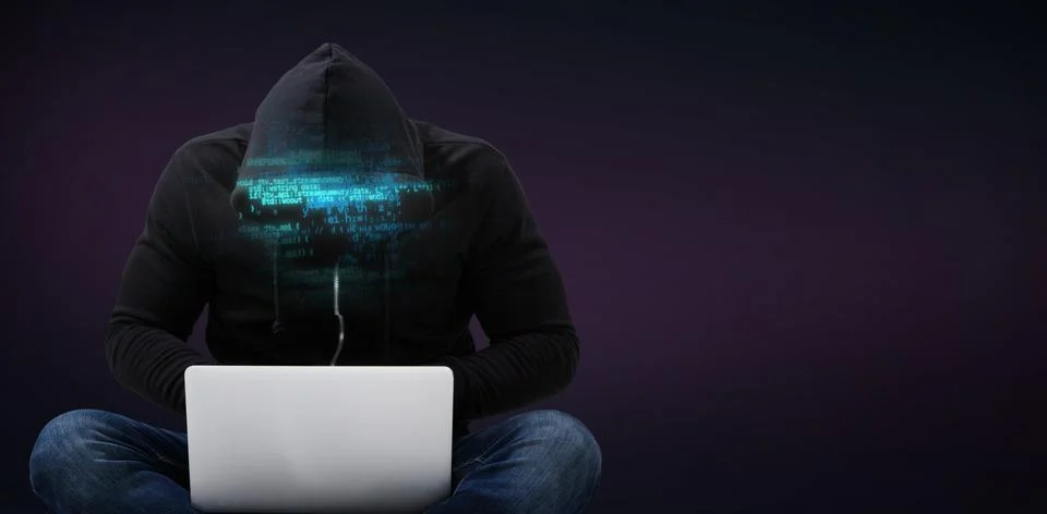 Composite image of male hacker using laptop 스톡 사진