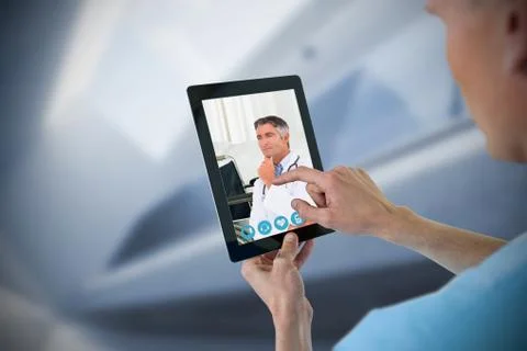 Composite image of male nurse using digital tablet Foto stock