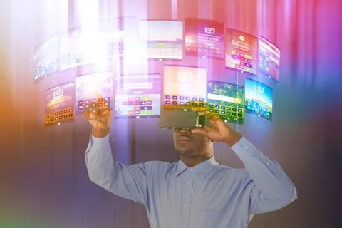 Composite image of man standing while wearing virtual reality simulator Stock Photos