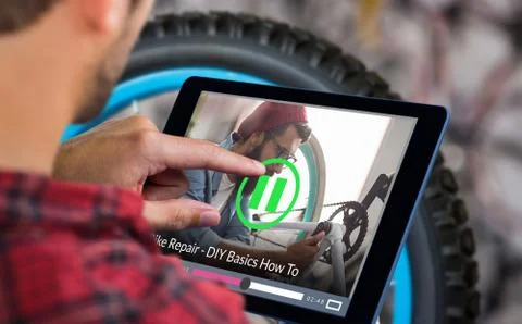 Composite image of man using tablet on wooden table Stock Photos