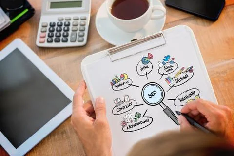 Composite image of man writing on clipboard on working desk Illustrazione stock