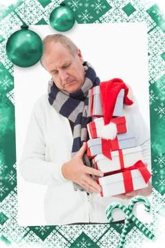 Composite image of mature man in winter clothes holding gifts イラスト素材