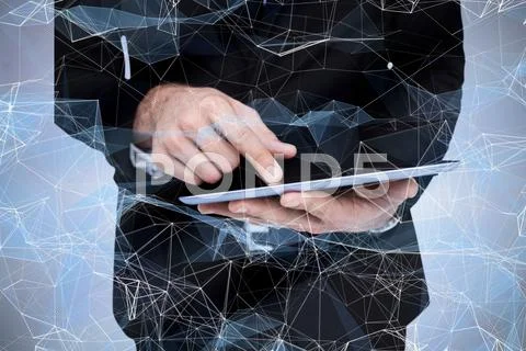 Composite Image Of Mid Section Of A Businessman Touching Digital Tablet