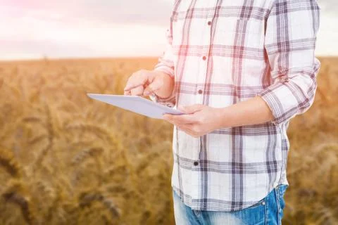 Composite image of mid section of man using tablet computer Foto stock