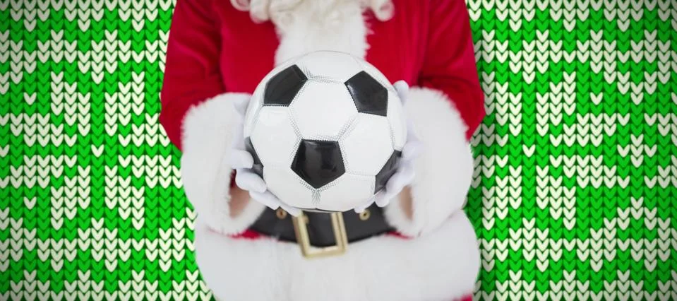 Composite image of mid section of santa holding football Foto stock