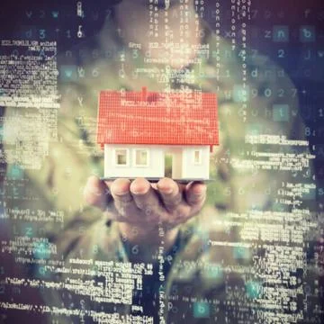 Composite image of mid section of soldier holding model house 写真素材