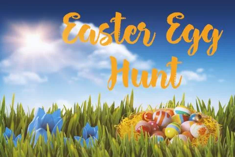 Composite image of multi colored easter eggs in wicker basket Stock-Fotos