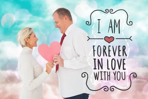 Composite image of older affectionate couple holding pink heart shape Stock Illustration