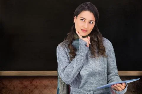 Composite image of pensive model wearing winter clothes holding her tablet Illustrazione stock