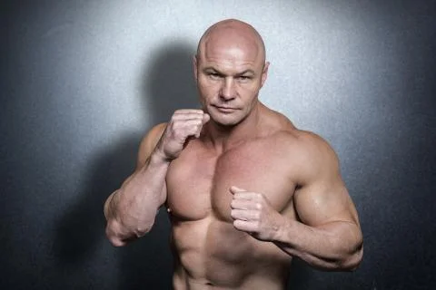 Composite image of portrait of bald man with boxing pose Stock Photos