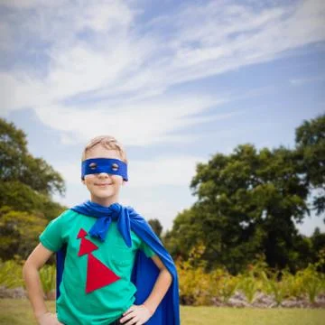 Composite image of portrait of boy in blue eye mask and cape Stock Photos