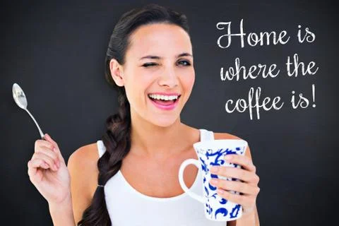 Composite image of pretty brunette having cup of tea Illustrazione stock