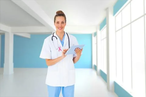Composite image of pretty nurse using tablet pc Stock Photos