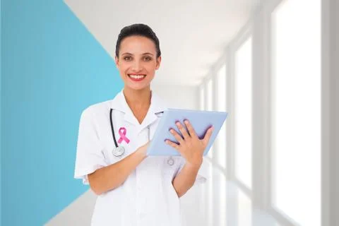Composite image of pretty nurse using tablet pc Stock Photos