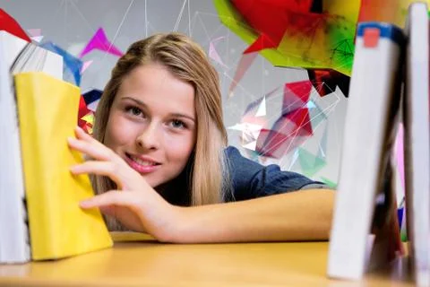 Composite image of pretty student in the library Stock Photos