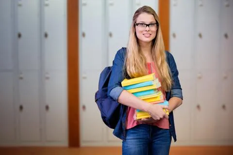 Composite image of pretty student in the library 库存照片