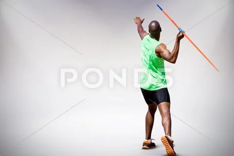 Composite image of rear view of man throwing javeline against white backgroun Stock Photos