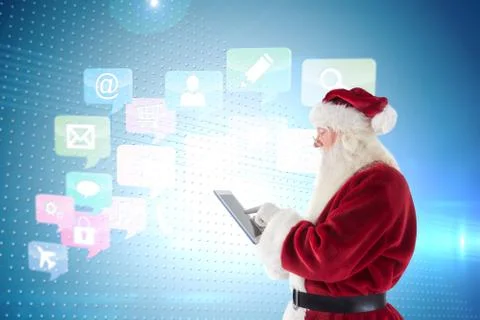 Composite image of santa uses a tablet pc Stock Photos