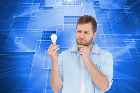 Composite image of sceptical model holding a bulb Illustrazione stock