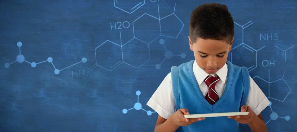 Composite image of schoolboy using digital tablet Stock Photos