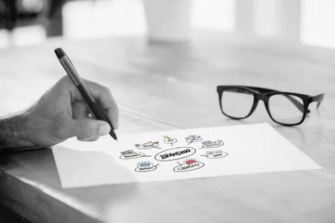 Composite image of side view of hand writing on white page on working desk Stock Illustration