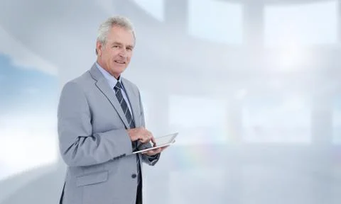 Composite image of side view of mature tradesman with tablet computer Foto stock