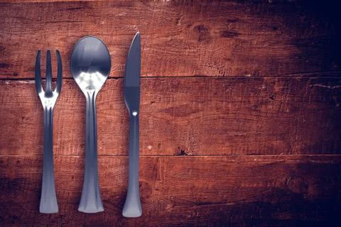 Composite image of silver knife, fork and spoon Stock Illustration