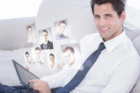 Composite image of smiling businessman using digital tablet Illustrazione stock