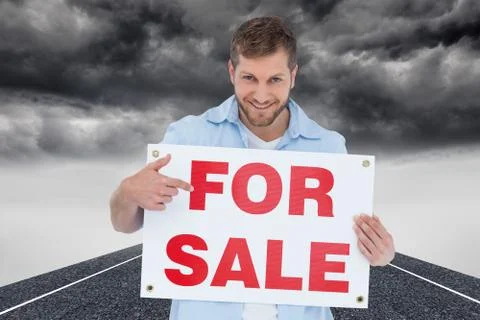 Composite image of smiling model holding a for sale sign Stock Illustration