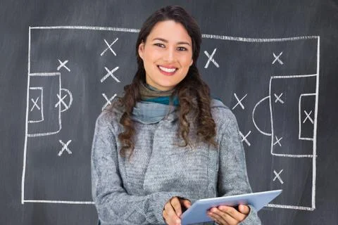 Composite image of smiling model wearing winter clothes holding her tablet Stock Illustration