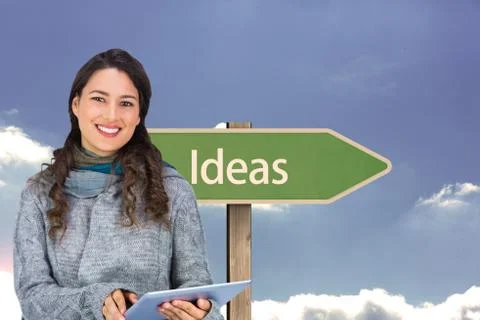 Composite image of smiling model wearing winter clothes holding her tablet Stock Illustration