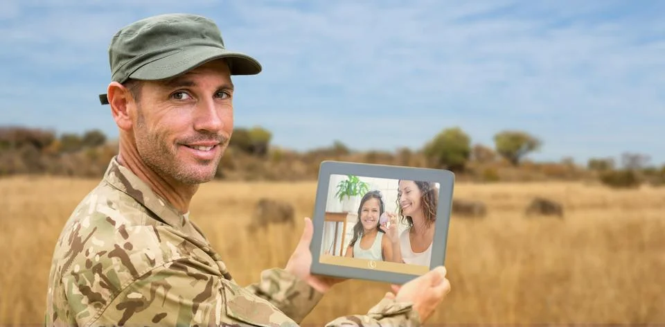Composite image of soldier using tablet pc Stock-Fotos